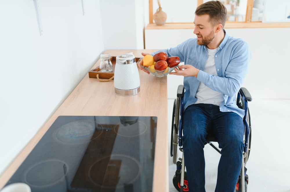 Disabled,young,man,in,wheelchair,preparing,food,in,kitchen